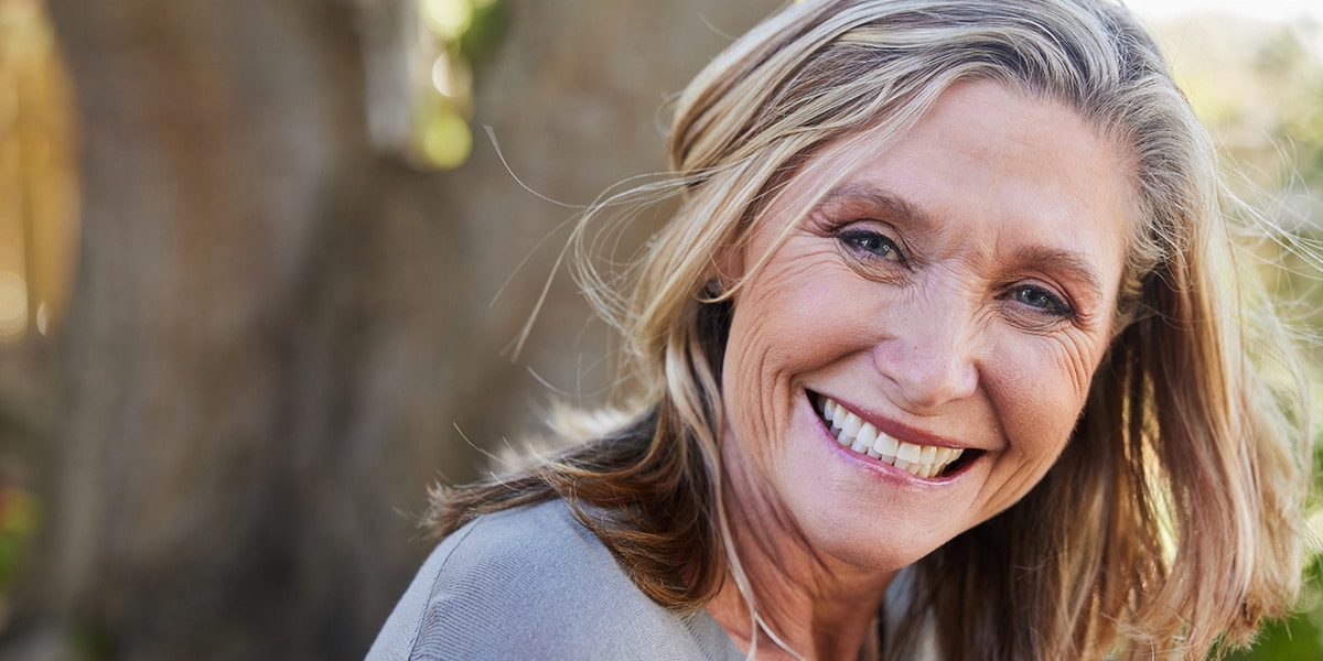 Smiling Woman By Tree
